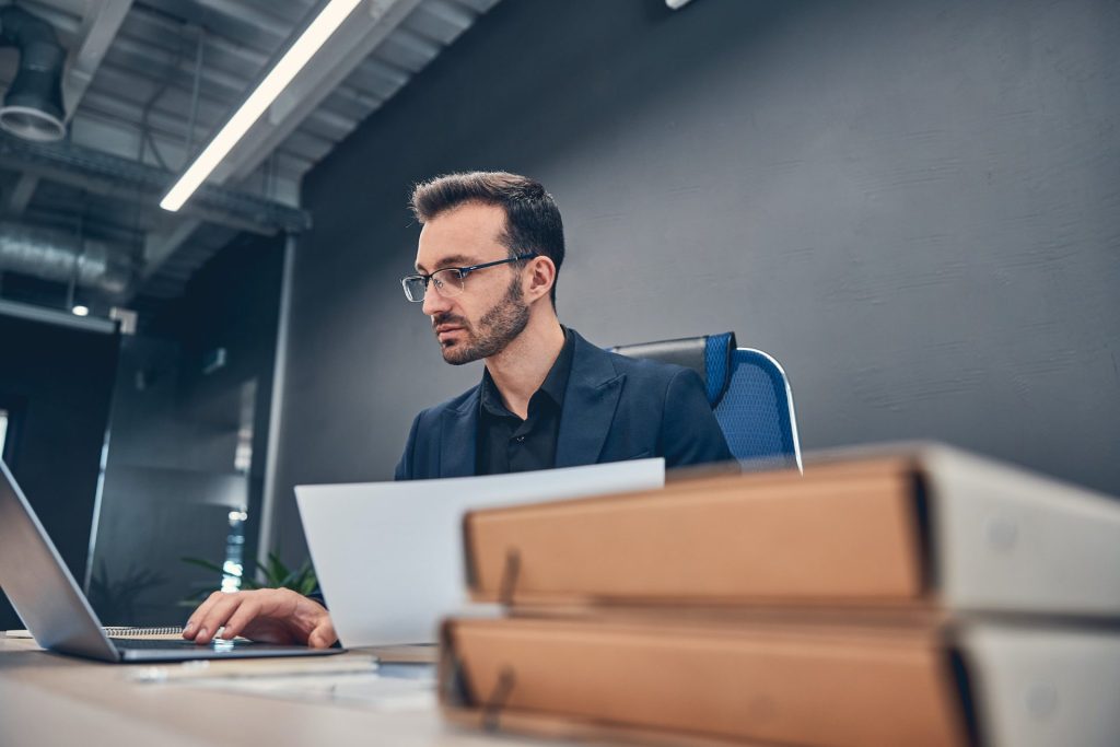 Financial accountant working on the laptop at the office desk